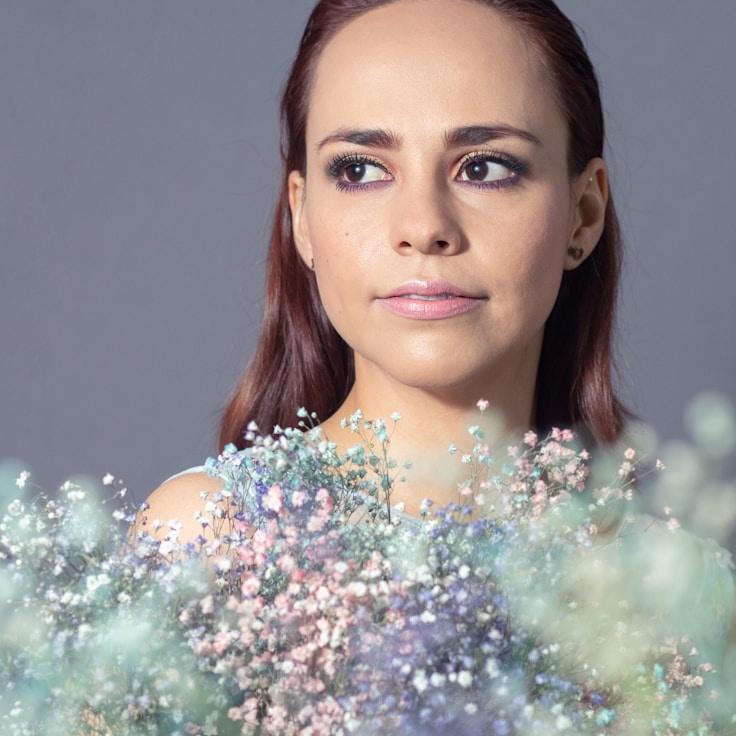 Alex Rivera, Lead Design Curator at Quanti Revolabs, reviewing corporate floral arrangements